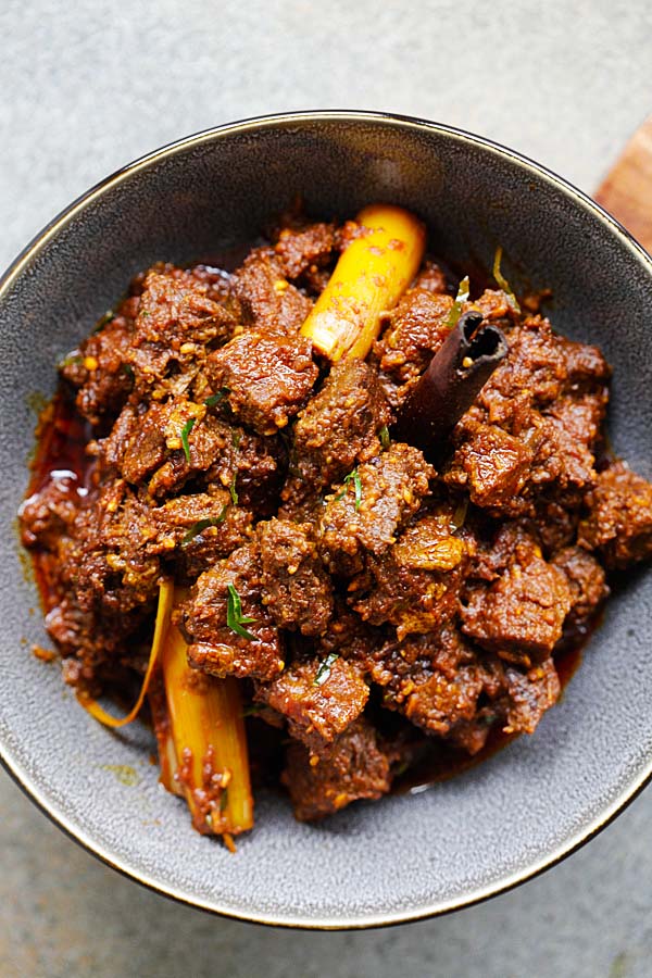 Easy authentic beef rendang recipe with beef, spices and coconut milk in a bowl.