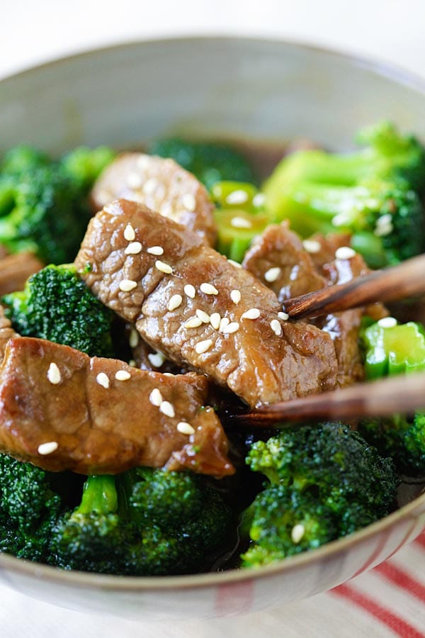 Tender beef and broccoli stir fry in a Chinese bowl, with a pair of chopsticks, ready to serve.
