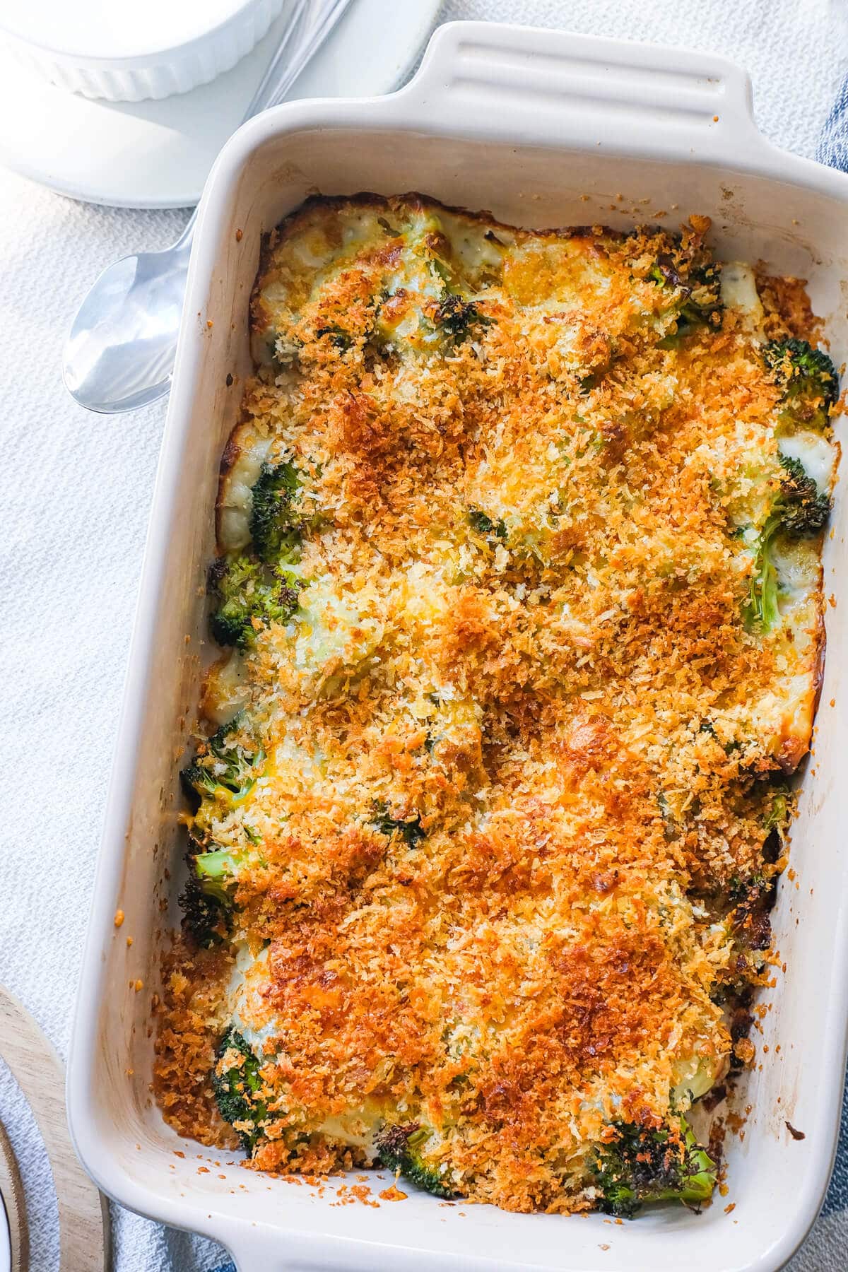 Perfectly baked broccoli gratin topped with bread crumbs in a baking dish. 