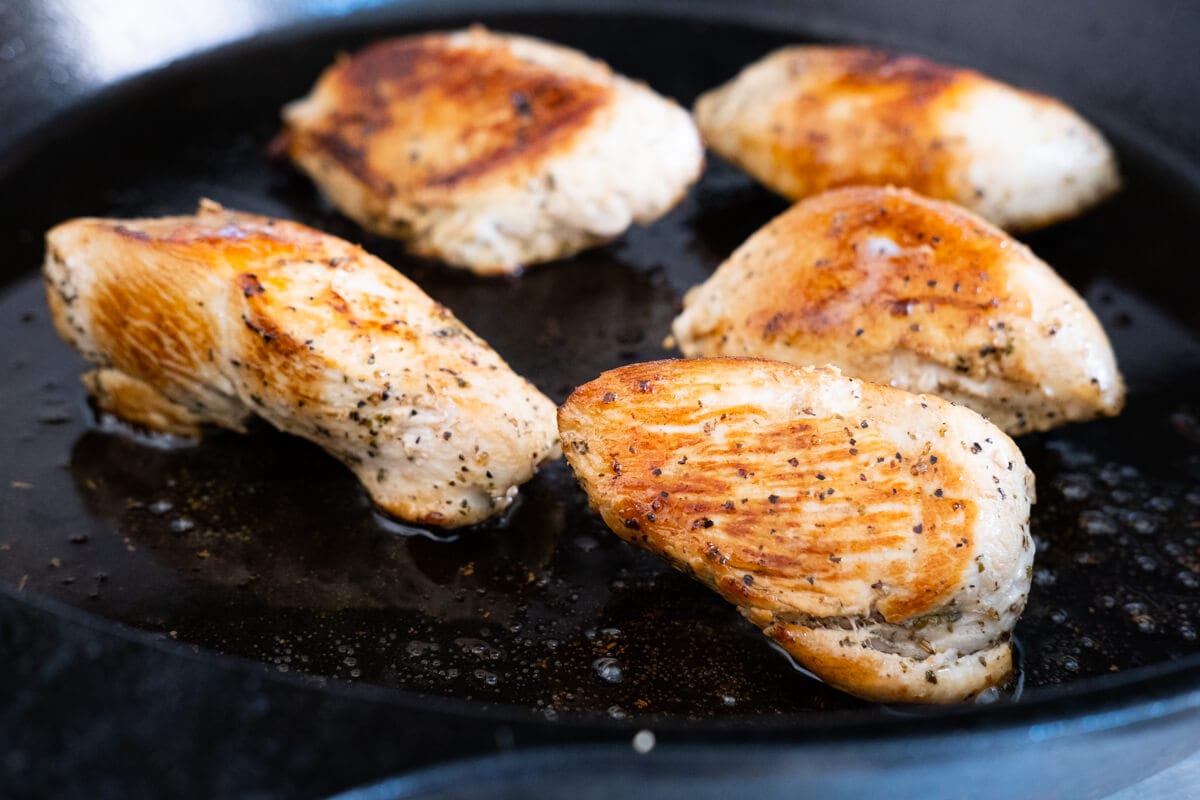 Marinated of chicken breast heated on a cast-iron skillet. 