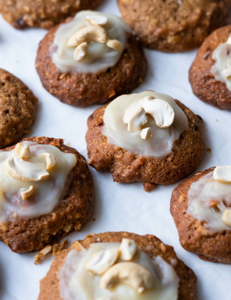 Frosting cashew cookies with cashew on top.