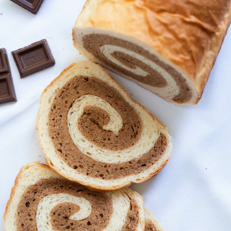 Chocolate cake bread with a few chocolate bar on the side.
