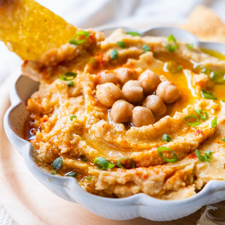 Hummus dip with corn chips.