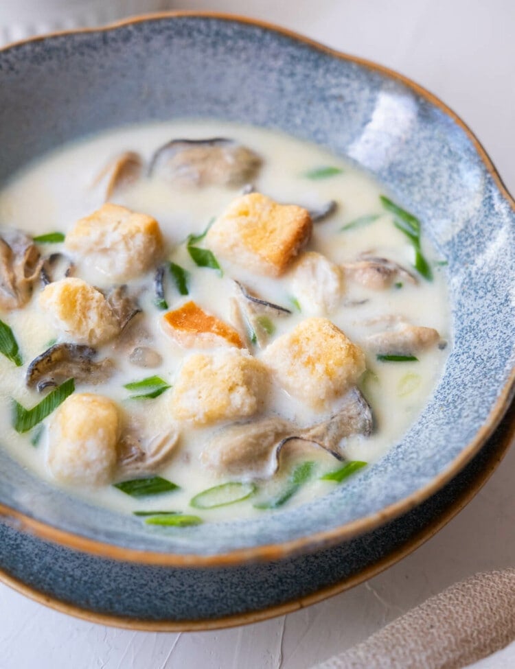 Oyster stew in milk-based broth and topped with croutons.