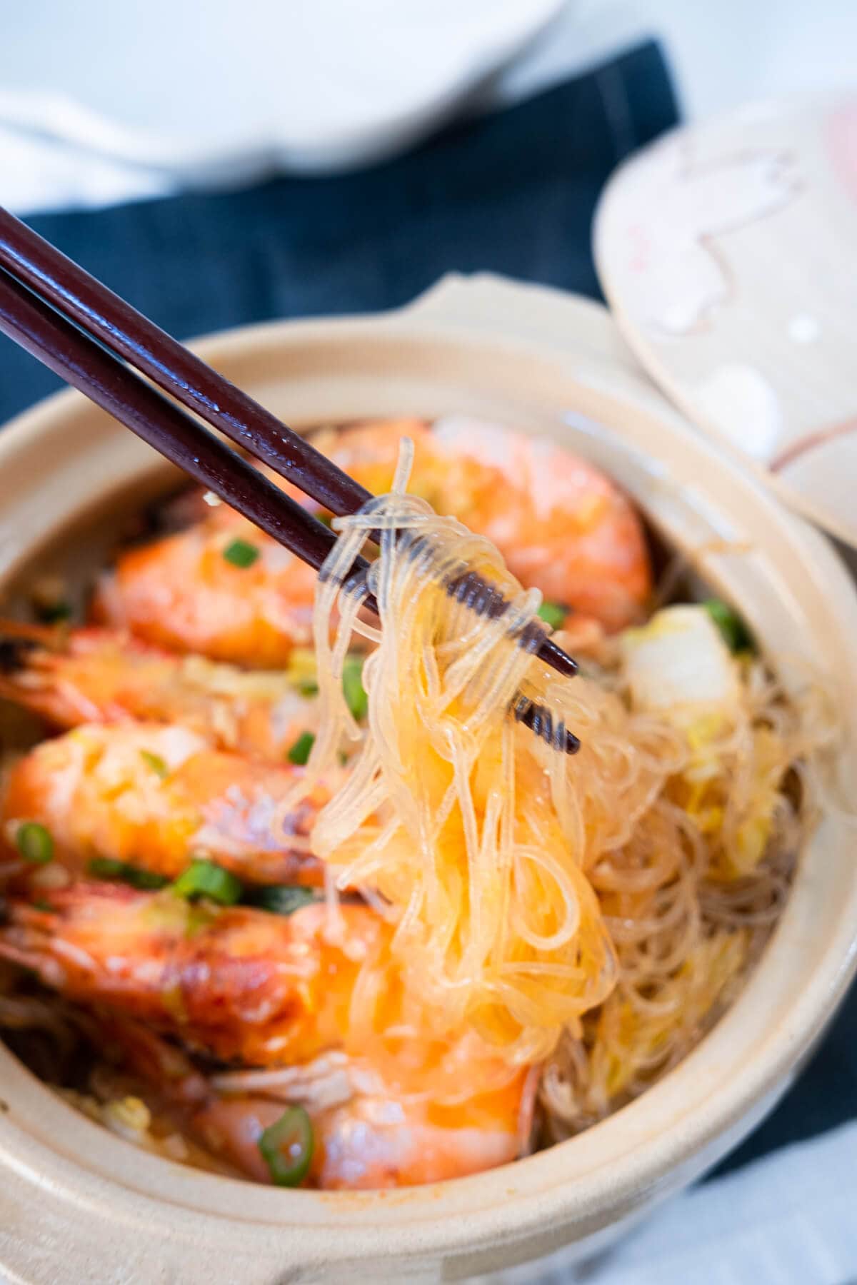 Glass noodles are picked up by chopsticks. 