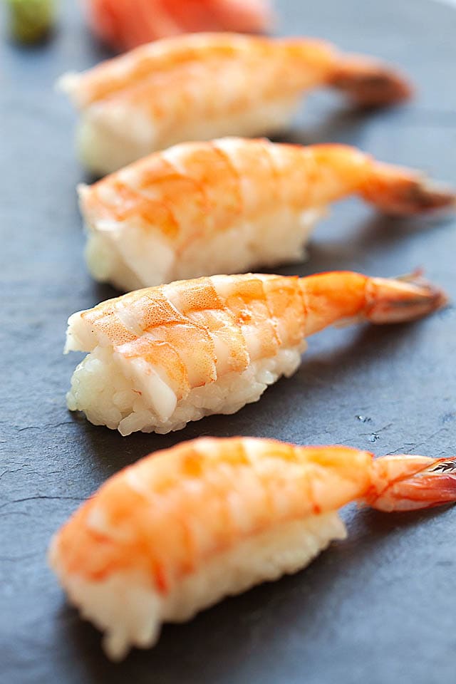 Shrimp nigiri on sushi board.